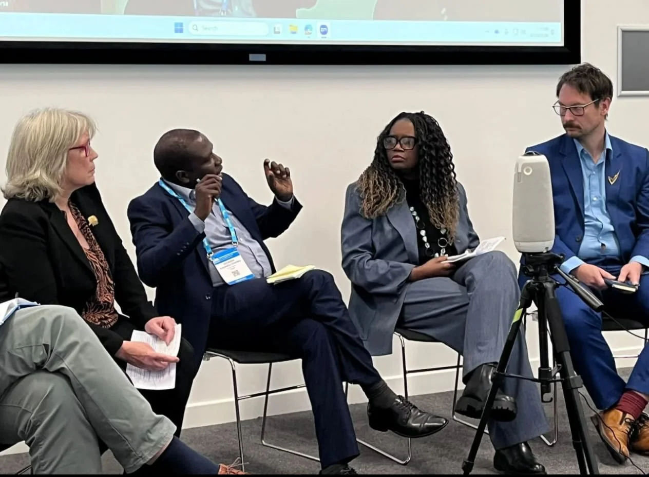 Petri Autio, seated at right, listening to a fellow speaker during the Beyond Aid panel